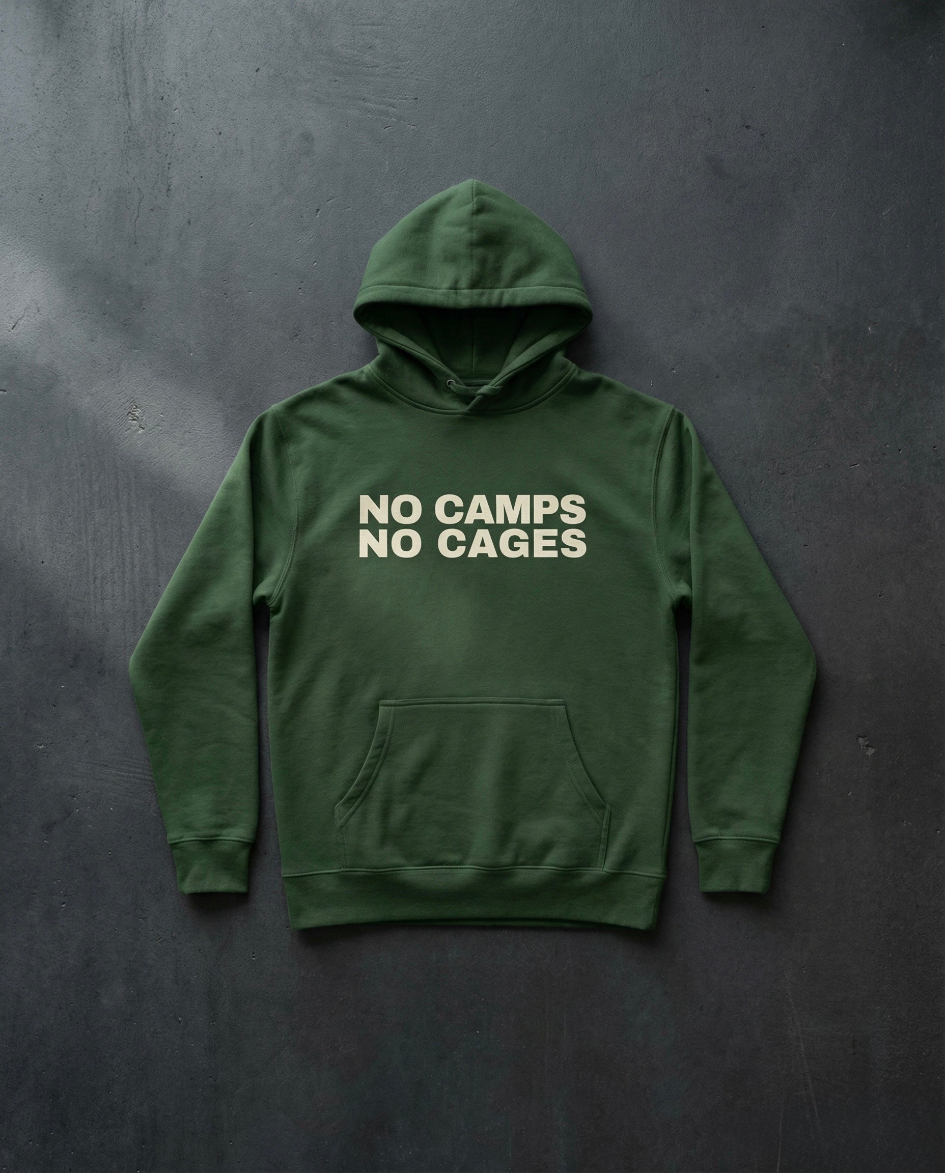 NO CAMPS NO CAGES Hoodie concrete background in forest | BAD BUREAU