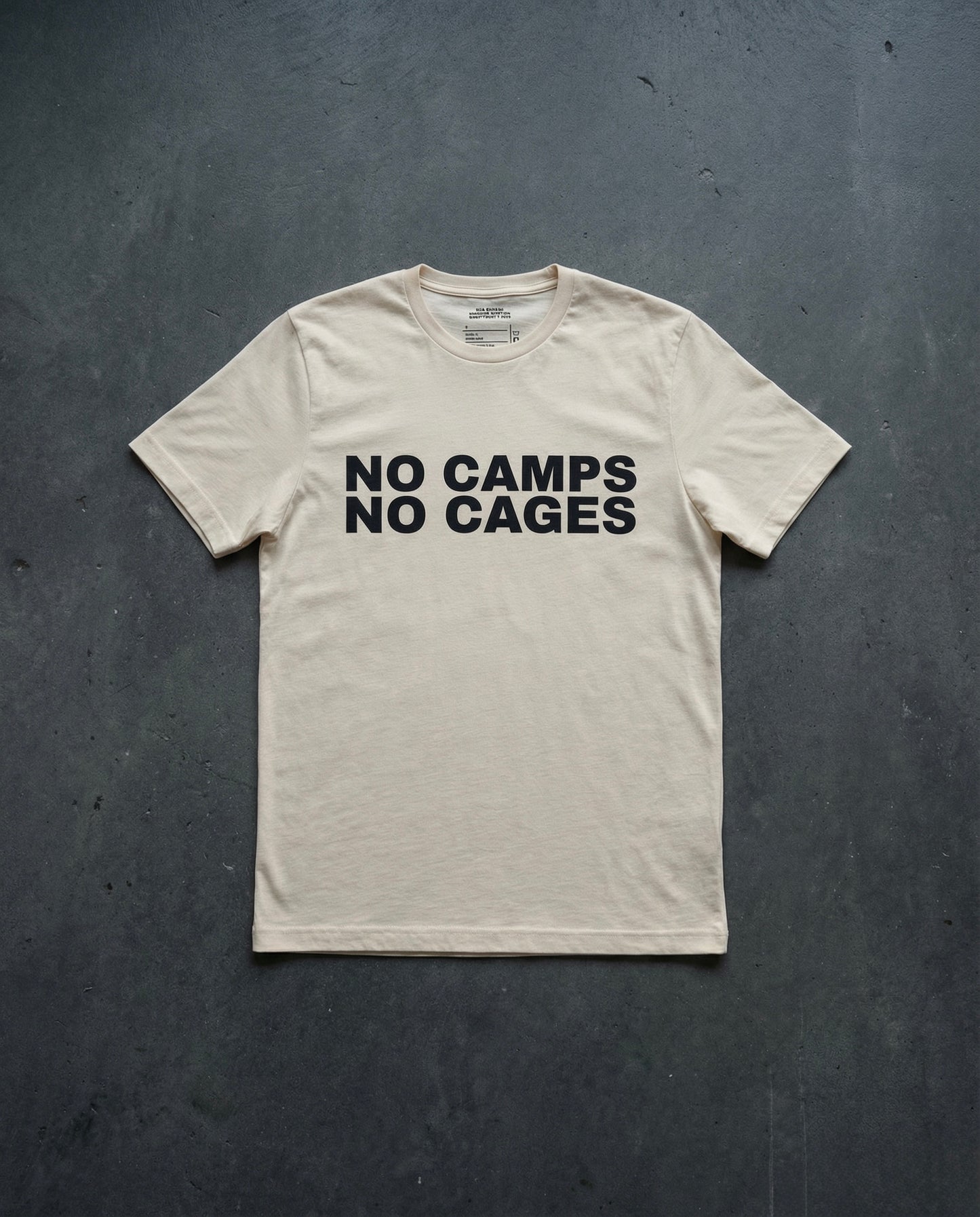 NO CAMPS NO CAGES T-Shirt concrete background in bone | BAD BUREAU
