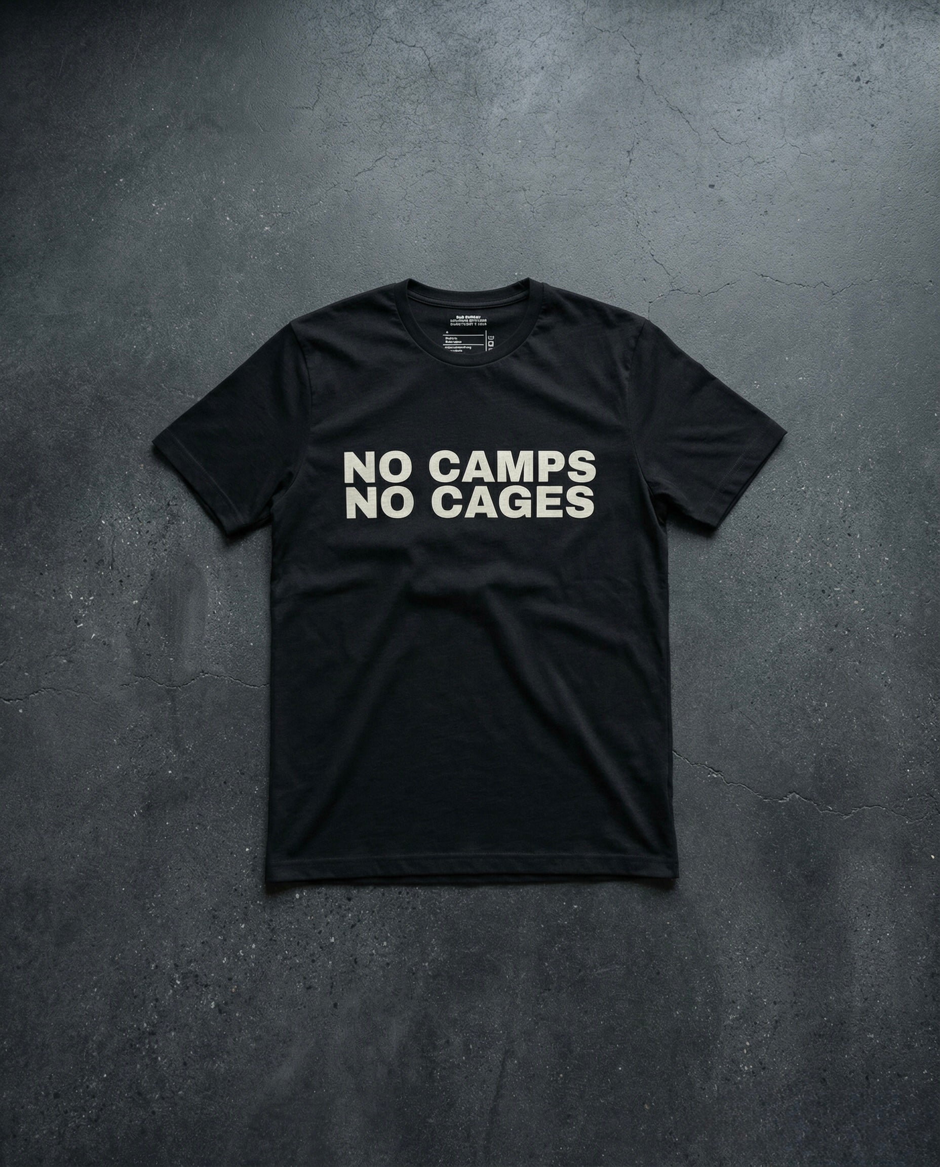 NO CAMPS NO CAGES T-Shirt concrete background in dark grey | BAD BUREAU